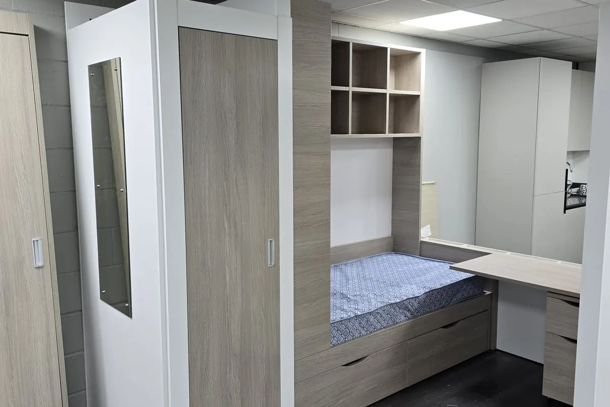 Student room furniture with integrated bed, shelving and desk