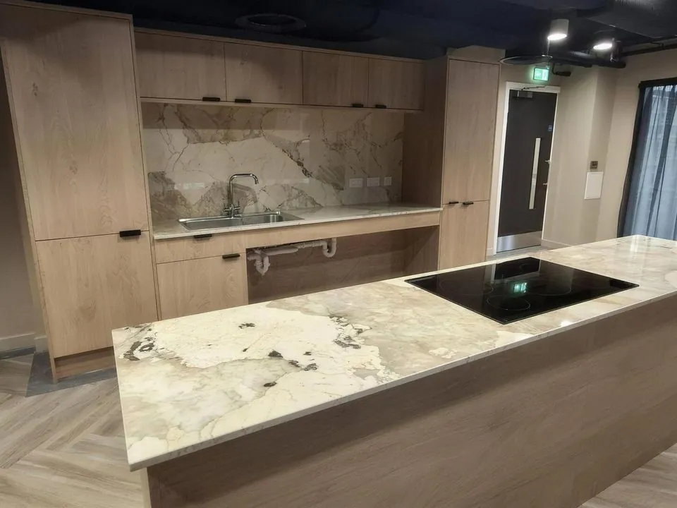 Communal kitchen with an island and fitted timber cabinetry